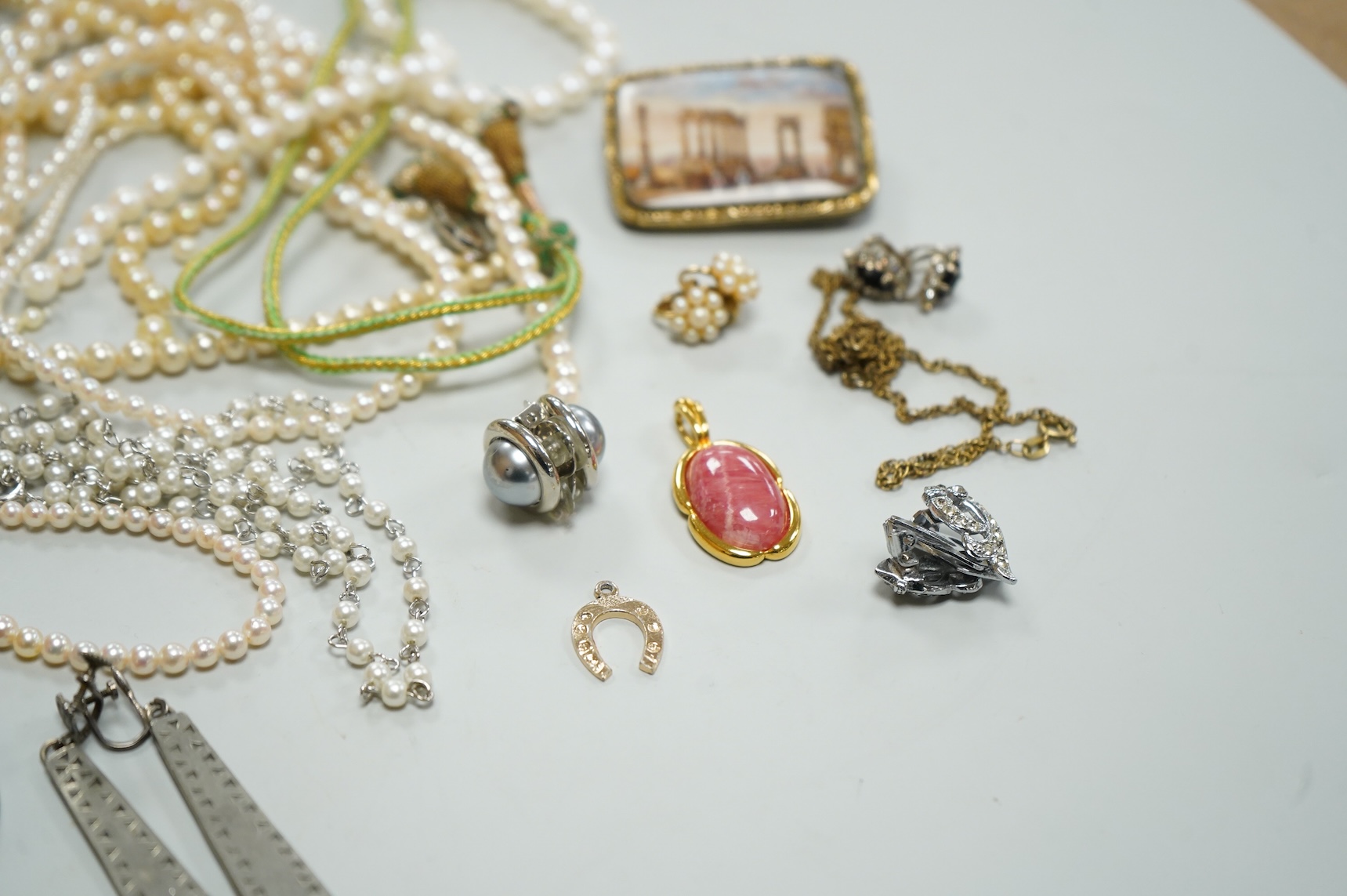 A collection of assorted jewellery including a jade bangle, cultured pearl necklaces and a diamond set yellow metal and quartz ring.